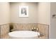 Relaxing bathroom featuring a soaking tub, tile accents, and soft lighting at 1275 Washington Ave, Golden, CO 80401