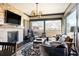 Open concept living room with stone fireplace, area rug, mountain views and comfortable furniture at 1275 Washington Ave, Golden, CO 80401