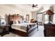 Spacious main bedroom with a large, decorative wood frame bed, ceiling fan and natural light at 1275 Washington Ave, Golden, CO 80401