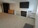 Finished basement with a fireplace, a TV, white shelving, neutral carpets, and minimal furnishings at 10522 Stoneflower Dr, Parker, CO 80134