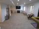 Finished basement with neutral carpet, a fireplace, and shelving for flexible living and entertainment at 10522 Stoneflower Dr, Parker, CO 80134