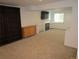 Finished basement featuring neutral carpet, fireplace, television, and bookcase at 10522 Stoneflower Dr, Parker, CO 80134