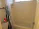 Functional bathroom features a shower-tub combination with a white shower curtain, and a toilet at 10522 Stoneflower Dr, Parker, CO 80134
