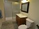 Updated bathroom features a modern vanity with a sink, glass-enclosed shower, and tiled flooring at 10522 Stoneflower Dr, Parker, CO 80134