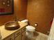 Unique half bath with a copper sink, granite countertops, and stylish fixtures for a rustic feel at 10522 Stoneflower Dr, Parker, CO 80134