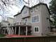 Spacious home exterior featuring a deck, large windows, and gray siding at 10522 Stoneflower Dr, Parker, CO 80134