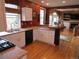 Bright kitchen features white cabinets, granite countertops, and a breakfast bar with wood floors throughout at 10522 Stoneflower Dr, Parker, CO 80134