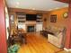 Cozy living room with a fireplace, built-in shelves, and a large TV perfect for Gathering movie nights at 10522 Stoneflower Dr, Parker, CO 80134