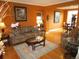 Warm living room with hardwood floors, comfortable seating, and decorative accents at 10522 Stoneflower Dr, Parker, CO 80134
