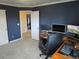 Spacious office featuring a neutral carpet, blue accent wall, and bright white trim at 10522 Stoneflower Dr, Parker, CO 80134