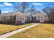 Quaint home with brick exterior, blue shutters, and a well-manicured lawn, offering great curb appeal at 1257 Locust St, Denver, CO 80220