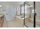 This bathroom features a glass-enclosed tile shower and a soaking tub beneath a bright window at 13475 Spruce St, Thornton, CO 80602
