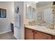 Powder room features a wood vanity, framed mirror, decorative hand towels and decor at 13475 Spruce St, Thornton, CO 80602