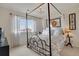 Charming bedroom with a four-poster bed, neutral walls, and a chandelier adding a touch of elegance at 13475 Spruce St, Thornton, CO 80602