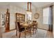 Dining room with chandelier, china cabinet and large windows for ample natural light at 13475 Spruce St, Thornton, CO 80602