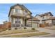 Two-story home with landscaped front yard, covered porch, and two-car garage, set in a suburban neighborhood at 13475 Spruce St, Thornton, CO 80602