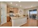 Bright kitchen with stainless steel appliances, granite countertops, and an island with sink, adjoining to the dining area at 13475 Spruce St, Thornton, CO 80602