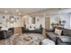 Cozy living room with gray sofa, patterned rug, hardwood floors, and fireplace at 13475 Spruce St, Thornton, CO 80602