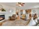 Open concept living room featuring hardwood floors, fireplace, and a view into the kitchen and dining area at 13475 Spruce St, Thornton, CO 80602