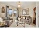 Bright living room featuring large windows, neutral tones, and ample seating at 13475 Spruce St, Thornton, CO 80602