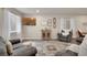 Relax in this comfy living room with a decorative cabinet and neutral colors at 13475 Spruce St, Thornton, CO 80602