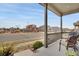 Inviting covered porch with comfortable seating, offering views of the neighborhood park and playground at 13475 Spruce St, Thornton, CO 80602
