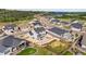 Aerial view of a neighborhood with fenced yards, patios, and views of the mountains at 5446 Mesa Top Dr, Monument, CO 80132
