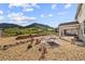 Large backyard with gravel landscaping, a hammock, and stunning mountain views at 5446 Mesa Top Dr, Monument, CO 80132