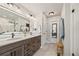 Modern bathroom features double sinks, a long vanity, a tiled floor, and a glass-enclosed shower at 5446 Mesa Top Dr, Monument, CO 80132