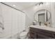 Modern bathroom featuring a shower with white subway tiles and a wood vanity at 5446 Mesa Top Dr, Monument, CO 80132