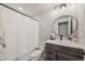 Modern bathroom featuring a shower with white subway tiles and a wood vanity at 5446 Mesa Top Dr, Monument, CO 80132