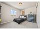 Cozy bedroom features a comfortable bed, natural light, neutral paint, and a closet door at 5446 Mesa Top Dr, Monument, CO 80132