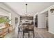 Open concept dining room with a kitchen view, a stylish dining table, and bright natural light at 5446 Mesa Top Dr, Monument, CO 80132