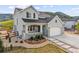 Charming two-story home featuring a three-car garage, inviting porch, and beautiful, low-maintenance landscaping at 5446 Mesa Top Dr, Monument, CO 80132