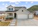 Charming two-story home featuring a three-car garage, inviting porch, and beautiful, low-maintenance landscaping at 5446 Mesa Top Dr, Monument, CO 80132