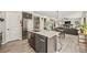 Bright kitchen showcasing stainless steel appliances, white countertops, barstool seating and an open layout to the living room at 5446 Mesa Top Dr, Monument, CO 80132