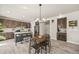 A spacious kitchen features an island with stool seating, stainless steel appliances and dark wood cabinetry at 5446 Mesa Top Dr, Monument, CO 80132
