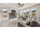 Bright living room with a stone fireplace, large windows with mountain views, and a comfortable gray sofa at 5446 Mesa Top Dr, Monument, CO 80132