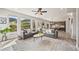 Bright living room with a gray sofa, large windows with mountain views, and an open floor plan at 5446 Mesa Top Dr, Monument, CO 80132