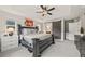 Main bedroom featuring a tray ceiling, a king-size bed, a sliding barn door, and bright windows at 5446 Mesa Top Dr, Monument, CO 80132