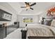 Spacious main bedroom with scenic views, a stylish ceiling fan, plush carpet and a large bed at 5446 Mesa Top Dr, Monument, CO 80132
