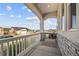 Charming covered front porch offers scenic neighborhood views and a comfortable seating area at 5446 Mesa Top Dr, Monument, CO 80132