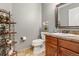 Half bathroom featuring a vanity, toilet, decorative shelf, and neutral wall color at 6852 S Algonquian Ct, Aurora, CO 80016