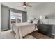 Well-lit bedroom with a cozy bed, patterned rug, and a view through the window at 6852 S Algonquian Ct, Aurora, CO 80016