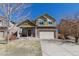 Charming two-story home featuring brick accents, a well-maintained lawn, and an attached two-car garage at 6852 S Algonquian Ct, Aurora, CO 80016