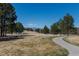 A beautiful green space area with a sidewalk and views of the distant mountain range at 6852 S Algonquian Ct, Aurora, CO 80016