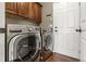 A practical laundry room area featuring modern, front-load washer and dryer units at 6852 S Algonquian Ct, Aurora, CO 80016