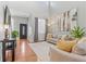 Spacious living room with a high ceiling, a gray sofa, a black door, and stylish decor at 6852 S Algonquian Ct, Aurora, CO 80016