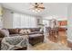 Open-concept living room with hardwood floors and large sectional sofa, perfect for entertaining guests at 6852 S Algonquian Ct, Aurora, CO 80016