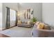 Elegant living room with modern gray sofas, a geometric rug, and sheer curtains for natural light at 6852 S Algonquian Ct, Aurora, CO 80016